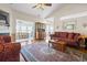 Cozy living room with hardwood floors, vaulted ceiling, and views into adjacent sunroom at 162 Jessica Lakes Dr., Conway, SC 29526