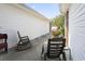 Porch featuring rocking chairs and landscaping at 162 Jessica Lakes Dr., Conway, SC 29526