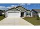 Charming single-Gathering home with a two-car garage, neat landscaping and a mix of horizontal and gabled siding at 177 Ashworth Dr., Tabor City, NC 28463