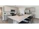 Modern kitchen featuring an island with bar stool seating, stainless steel appliances, and grey cabinetry at 177 Ashworth Dr., Tabor City, NC 28463
