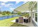 Scenic backyard view with patio seating, a retractable awning, and a peaceful waterfront setting at 1827 Parish Way, Myrtle Beach, SC 29577