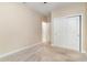 Bedroom with neutral walls and carpet, featuring a sliding door closet and doorway to the connecting bathroom at 1827 Parish Way, Myrtle Beach, SC 29577