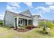 Well-maintained home featuring manicured landscaping, a covered porch, and a driveway leading to a two-car garage at 1827 Parish Way, Myrtle Beach, SC 29577