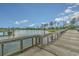 Picturesque lake view with a wooden walkway, mature trees, and distant residential area providing a serene backdrop at 1827 Parish Way, Myrtle Beach, SC 29577