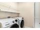Functional laundry room featuring Samsung washer and dryer, a storage shelf and neutral colored walls at 1827 Parish Way, Myrtle Beach, SC 29577