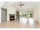 Bright living room featuring a fireplace, built-in shelving, ceiling fan, and natural light at 1827 Parish Way, Myrtle Beach, SC 29577