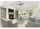 Bright living room with a fireplace, modern furniture, high ceilings, and large windows that offer scenic views at 1827 Parish Way, Myrtle Beach, SC 29577