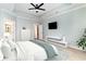Serene main bedroom with tray ceilings, soft colors, a ceiling fan, and a mounted TV at 1827 Parish Way, Myrtle Beach, SC 29577