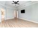 Spacious primary bedroom with light floors, ceiling fan, and access to the primary bathroom at 1827 Parish Way, Myrtle Beach, SC 29577