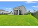 Expansive backyard with lush green lawn, patio, and screened porch at 189 Timber Oaks Dr., Myrtle Beach, SC 29588