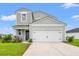 Charming two-story home with a well-manicured lawn and attached two car garage on a sunny day at 189 Timber Oaks Dr., Myrtle Beach, SC 29588