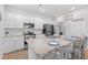 Modern kitchen featuring white cabinets, stainless steel appliances, and granite countertops with bar stool seating at 189 Timber Oaks Dr., Myrtle Beach, SC 29588