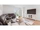 Bright living room with hardwood floors, sliding glass doors, and a comfortable, dark brown sectional sofa at 189 Timber Oaks Dr., Myrtle Beach, SC 29588