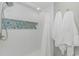 Clean and modern bathroom featuring white tiled walls with a glass tile accent in the shower at 200 72Nd Ave. N # 501, Myrtle Beach, SC 29572