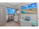 Bright bedroom with ocean view, desk, and flat screen TV displaying beach scenery at 200 72Nd Ave. N # 501, Myrtle Beach, SC 29572