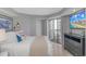 Comfortable bedroom featuring a beachfront view, TV, and sliding glass doors to private balcony at 200 72Nd Ave. N # 501, Myrtle Beach, SC 29572