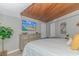 Bright bedroom featuring a wood ceiling, a flat-screen TV, a dresser, and nautical decor at 200 72Nd Ave. N # 501, Myrtle Beach, SC 29572