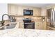 Modern kitchen featuring granite countertops and stainless steel appliances at 200 72Nd Ave. N # 501, Myrtle Beach, SC 29572