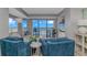 Bright living room with blue accent chairs, offers an ocean view balcony and built-in shelving at 200 72Nd Ave. N # 501, Myrtle Beach, SC 29572
