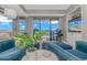 Cozy living room boasts comfortable blue chairs, a beach view, and sliding glass doors to a balcony at 200 72Nd Ave. N # 501, Myrtle Beach, SC 29572
