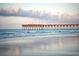Picturesque ocean pier at sunset with calming waves, creating a serene and inviting atmosphere for beachside enjoyment at 2004 Wild Indigo Circle Nw # 111, Calabash, NC 28467