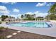 Community pool with crystal clear water, surrounded by a pergola, lush landscaping, and a white fence, creating a perfect oasis at 2004 Wild Indigo Circle Nw # 111, Calabash, NC 28467