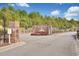 Community entrance featuring brick signage and wrought iron gates surrounded by landscaped greenery, welcoming residents to The Hamptons at 2004 Wild Indigo Circle Nw # 111, Calabash, NC 28467