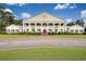 Elegant building featuring multiple columns, balconies, manicured landscaping, and a grand entrance, perfect for a luxurious lifestyle at 2004 Wild Indigo Circle Nw # 111, Calabash, NC 28467