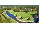 Aerial view of a lush golf course with picturesque ponds, manicured greens, and surrounding trees, creating a serene setting at 2004 Wild Indigo Circle Nw # 111, Calabash, NC 28467