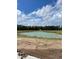 Scenic view of a tranquil pond surrounded by trees and open fields on a sunny day at 2030 Wild Indigo Circle Nw # 207, Calabash, NC 28467