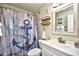 Nautical-themed bathroom featuring an anchor shower curtain, white vanity, and coastal decor at 210 N Ocean Blvd. # 234, North Myrtle Beach, SC 29582