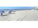 Picturesque beach with blue umbrellas and beach chairs along the pristine shoreline at 210 N Ocean Blvd. # 234, North Myrtle Beach, SC 29582