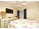 Comfortable bedroom featuring colorful seashell bedding, a dresser, a ceiling fan, and a window for natural light at 210 N Ocean Blvd. # 234, North Myrtle Beach, SC 29582