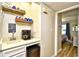 Charming coffee bar area with mini fridge, Keurig, floating shelves, and convenient access to the bedroom at 210 N Ocean Blvd. # 234, North Myrtle Beach, SC 29582