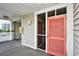 Condo entryway with storm and coral doors, painted trim and hardware, and a building exterior visible in the distance at 210 N Ocean Blvd. # 234, North Myrtle Beach, SC 29582