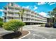 Three story condo building with multiple balconies and covered parking at 210 N Ocean Blvd. # 234, North Myrtle Beach, SC 29582