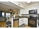 Well-equipped kitchen featuring stainless steel appliances, modern cabinets, and seamless flow into the living area at 210 N Ocean Blvd. # 234, North Myrtle Beach, SC 29582