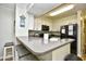 Bright kitchen boasts a breakfast bar, black appliances, and neutral countertops, perfect for casual dining at 210 N Ocean Blvd. # 234, North Myrtle Beach, SC 29582