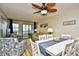 A bright and inviting living room with dining area, ceiling fan, sofa, chairs, and a sliding glass door to balcony at 210 N Ocean Blvd. # 234, North Myrtle Beach, SC 29582