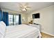 Cozy main bedroom with a comfy bed, balcony access, a large television and ample natural light at 210 N Ocean Blvd. # 234, North Myrtle Beach, SC 29582