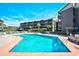 Inviting outdoor pool with deck chairs and seating, surrounded by beautifully maintained grounds at 210 N Ocean Blvd. # 234, North Myrtle Beach, SC 29582