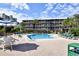Large pool and lounge area surrounded by resort buildings and palm trees at 210 N Ocean Blvd. # 234, North Myrtle Beach, SC 29582