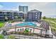 Lovely community pool and deck area with ample seating, surrounded by mature trees and lush landscaping at 210 N Ocean Blvd. # 234, North Myrtle Beach, SC 29582