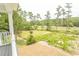 Charming backyard with new grass featuring marsh views and mature trees at 2212 Dykman Circle, Little River, SC 29566