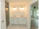 Bathroom featuring double sinks, a white vanity and a walk-in glass shower at 2212 Dykman Circle, Little River, SC 29566