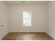 Bedroom with wood-look flooring, neutral walls, and a window for natural light at 2212 Dykman Circle, Little River, SC 29566