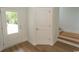Bright entryway with white trim, a glass door, and hardwood floors leading to the staircase at 2212 Dykman Circle, Little River, SC 29566