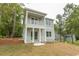 Two-story home with double porches, showcasing modern design and curb appeal at 2212 Dykman Circle, Little River, SC 29566