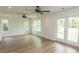 Bright living room with hardwood floors, neutral walls and sliding door to a balcony at 2212 Dykman Circle, Little River, SC 29566