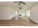 Open living room with hardwood floors, a modern fireplace, and large windows providing plenty of natural light at 2212 Dykman Circle, Little River, SC 29566